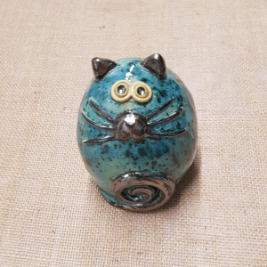 A decorative ceramic fat cat in dark green