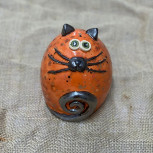 An ceramic fat cat in bright orange