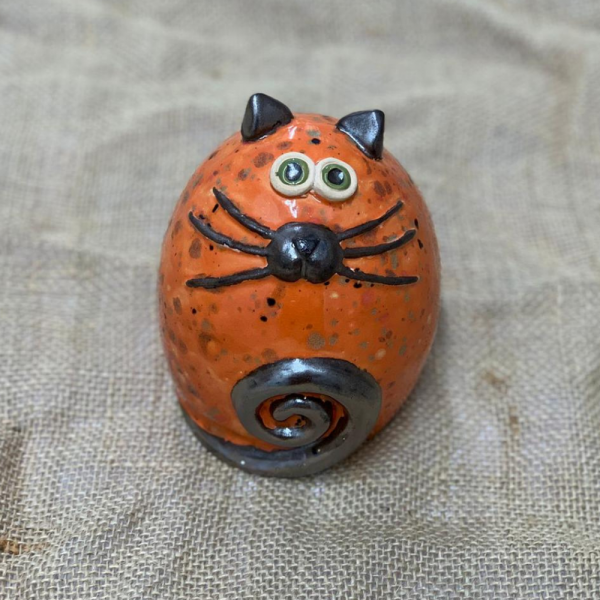 An ceramic fat cat in bright orange