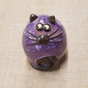 A decorative purple ceramic fat cat in purple